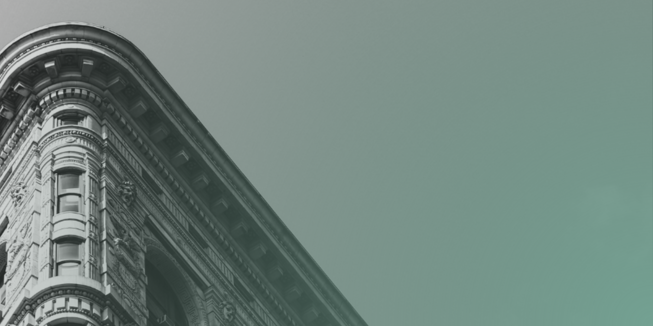 Corner view of an ornate historic building with carved arches and decorative details, grayscale overlaid with a teal gradient.